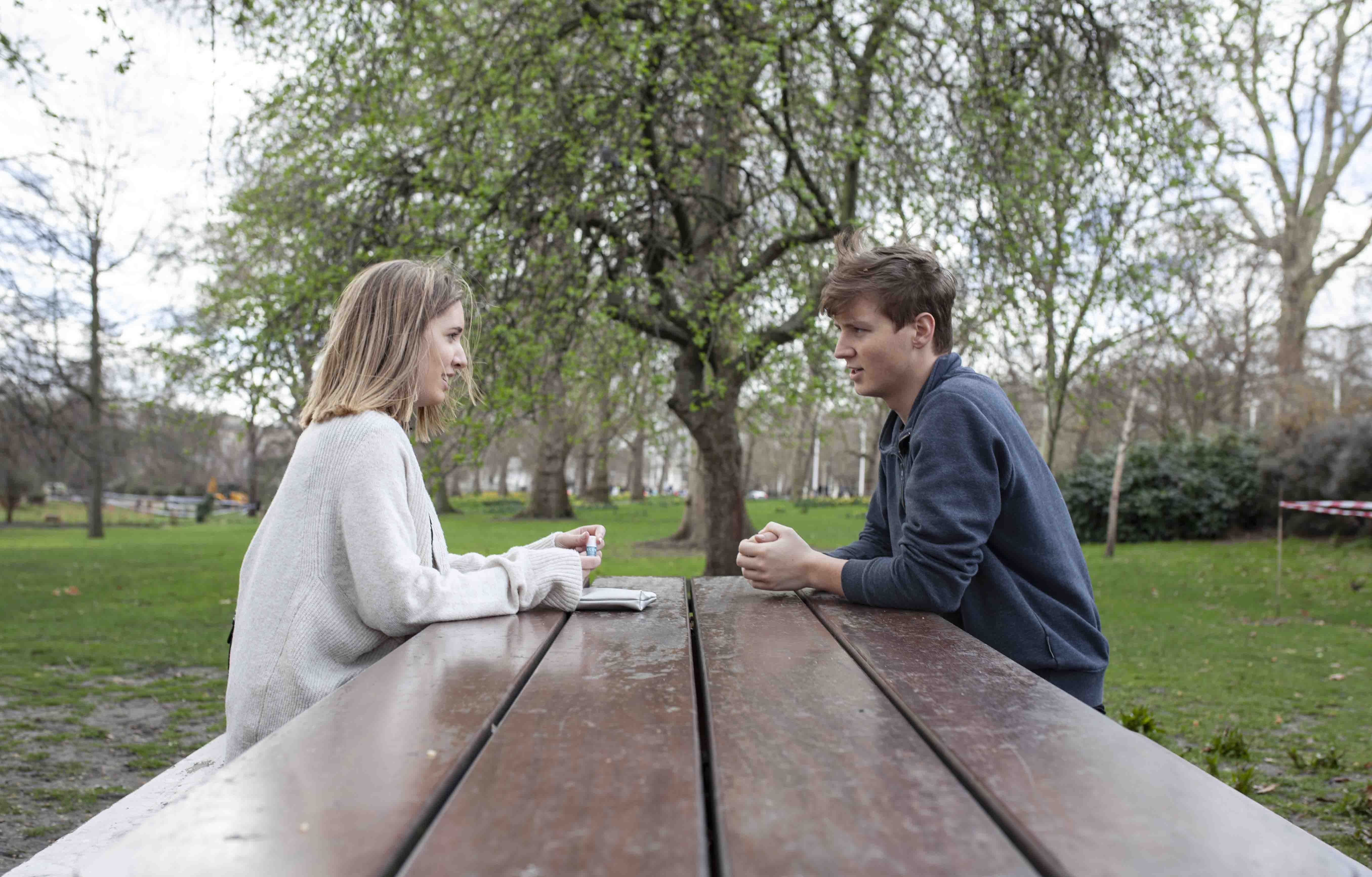 couple talking on a table outside