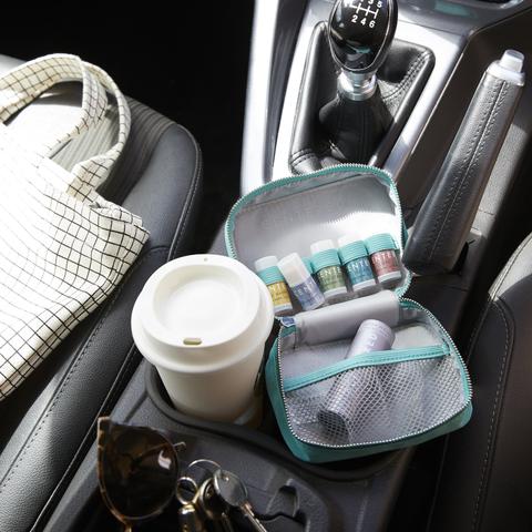 mini balms in the car next to coffee