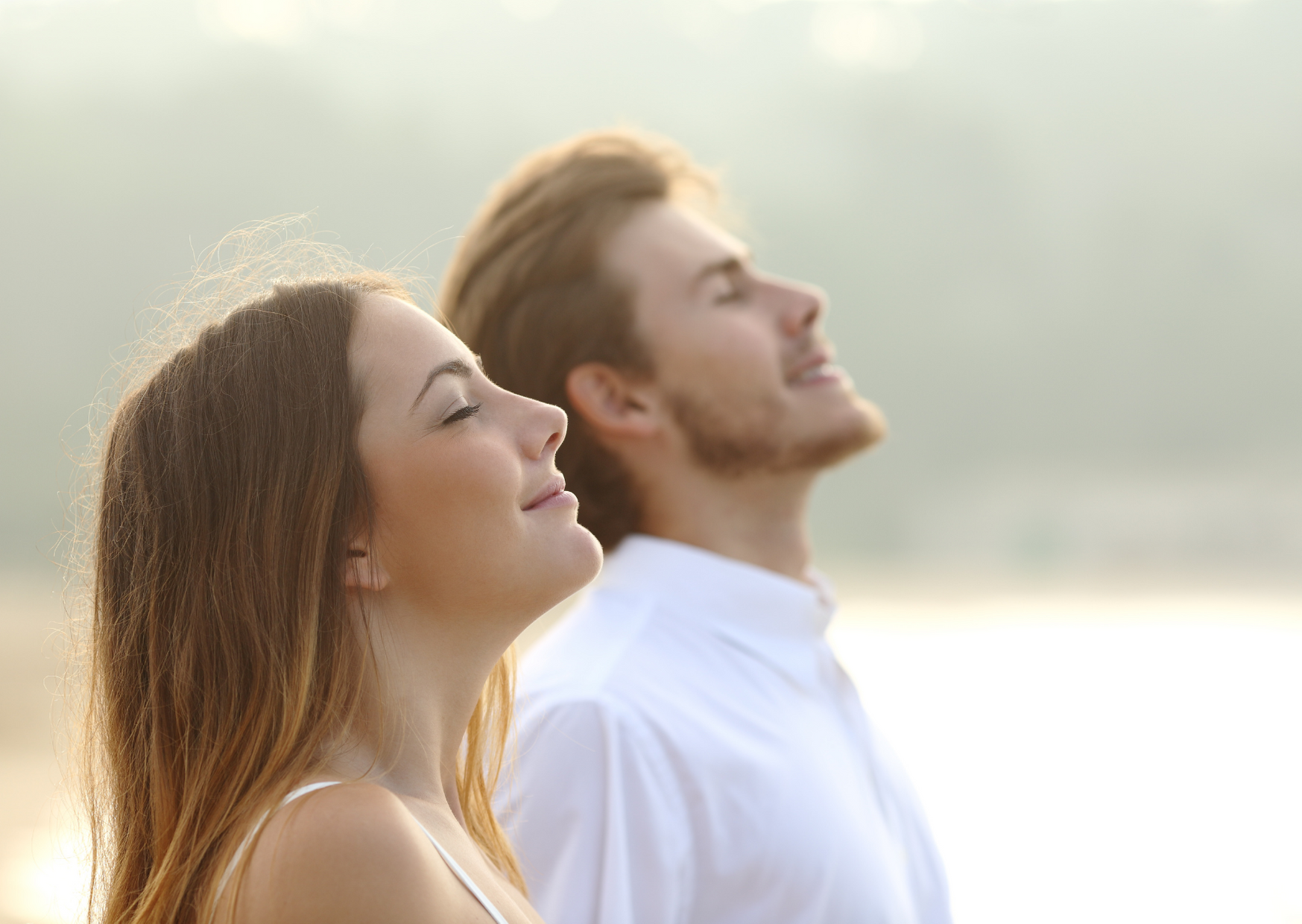 man and woman receiving the sun and smiling