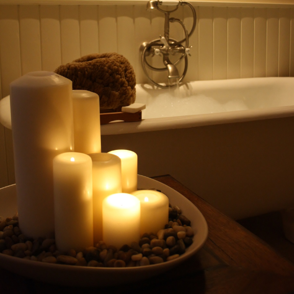 Candles next to a bubble bath