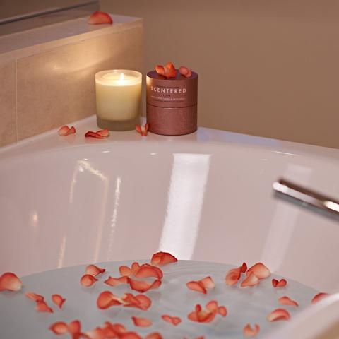 bath tub with petals and candles
