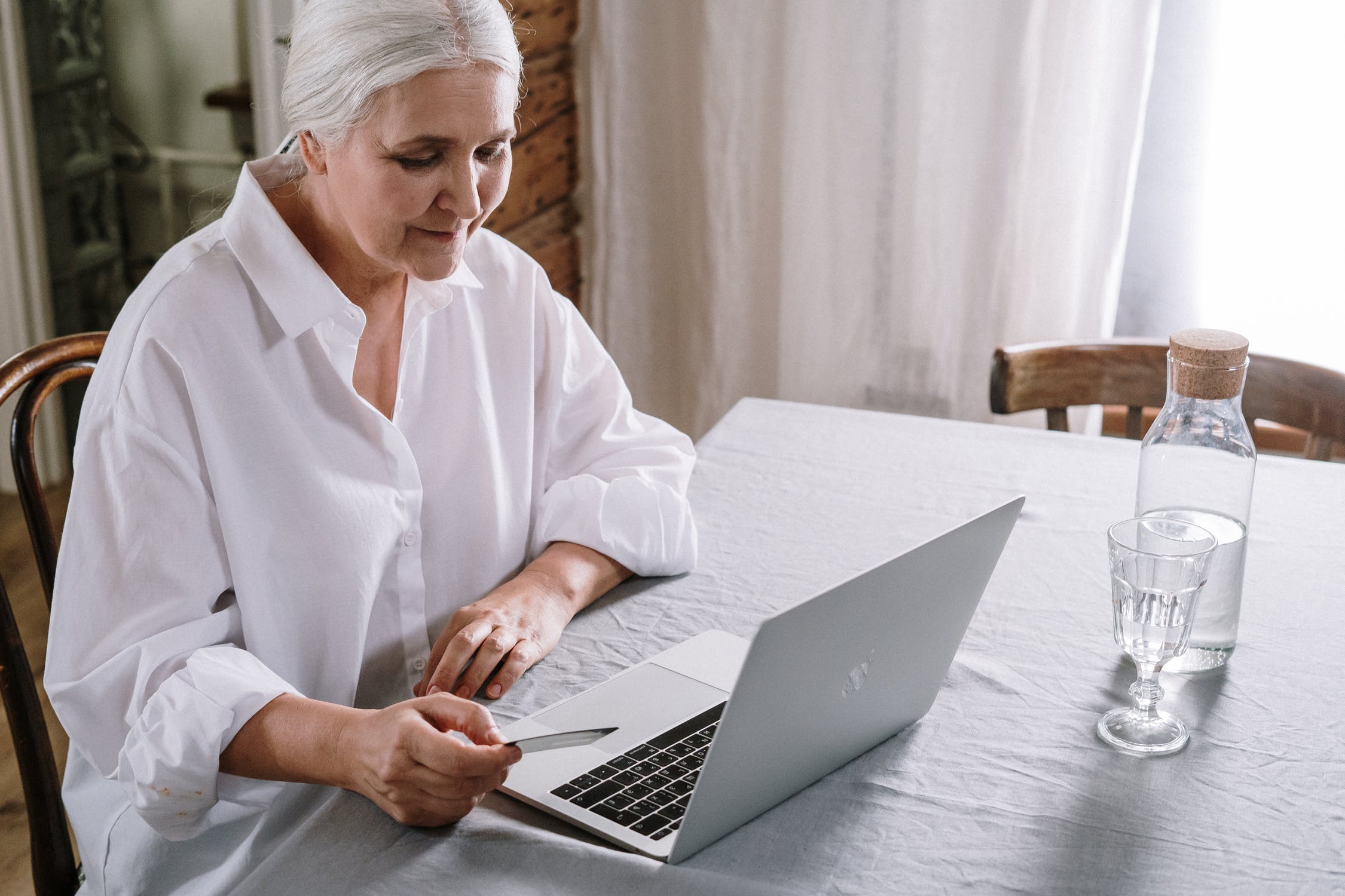 older woman in front of the laptop