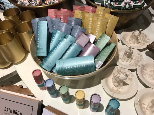 All 6 Scentered balms displayed in a bowl on a table