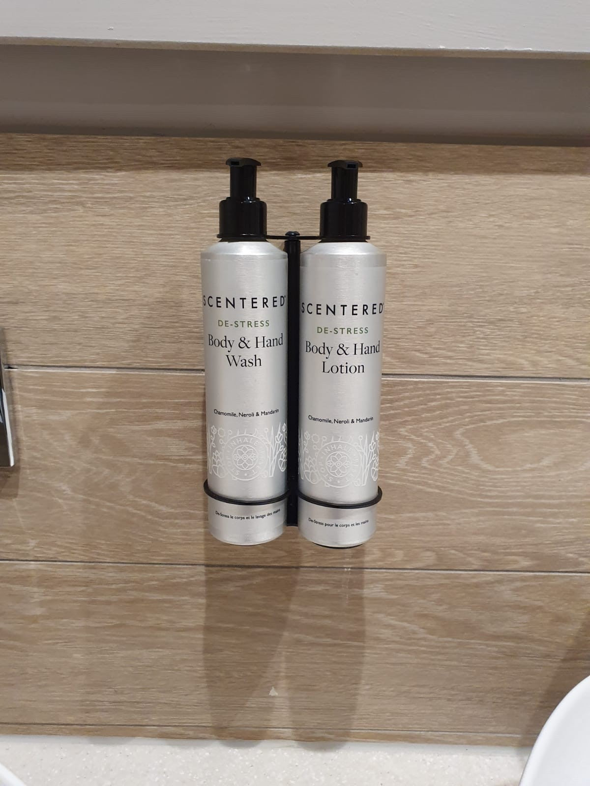Scentered De-Stress Wash and Scentered De-Stress Lotion Duo held in Wall Bracket on Wood Backing in Bathroom 