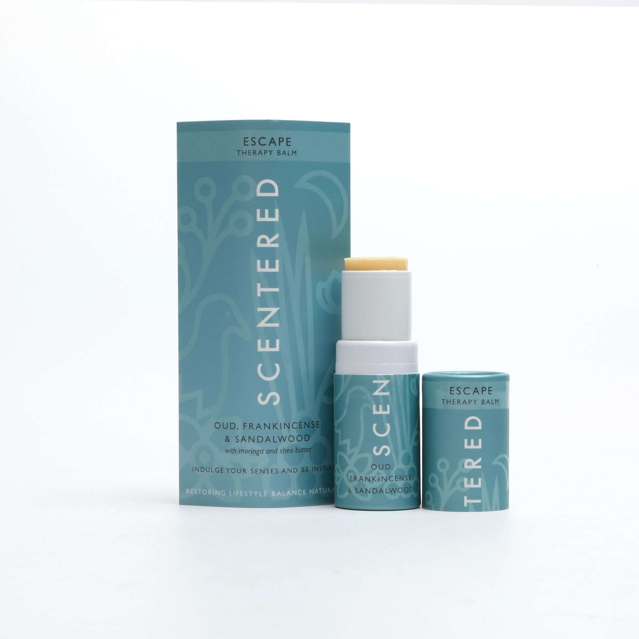 Escape Aromatherapy Balm with cap off and twisted up with eco sleeve packaging on a white background