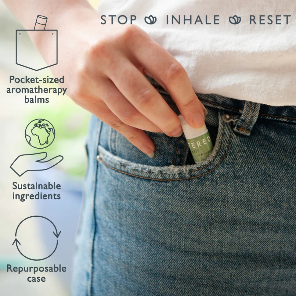 Scentered mini balm in womans hand as she puts into jean pocket, on the left hand side includes the infographics of all of the features pocket sized aromatherapy balms, sustainable ingredients and repurposable case